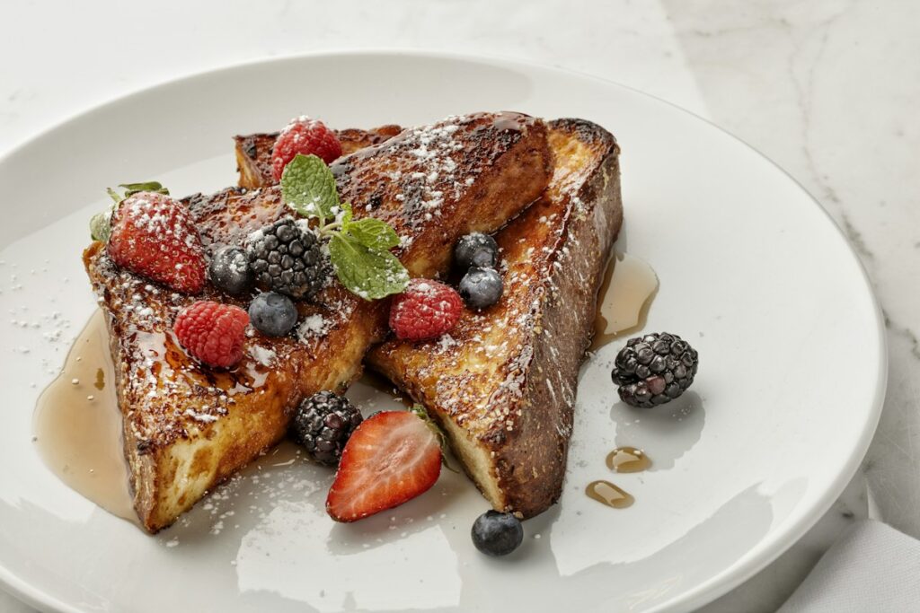 Golden French toast served with fresh mixed berries